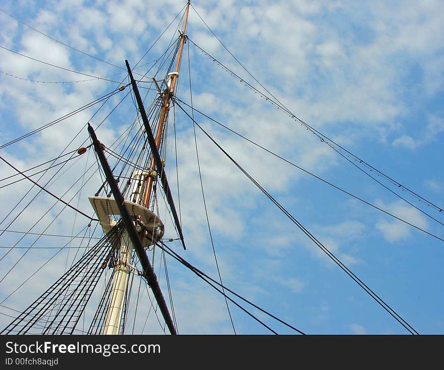 Mast of a ship pointing up through blue skies. Mast of a ship pointing up through blue skies.