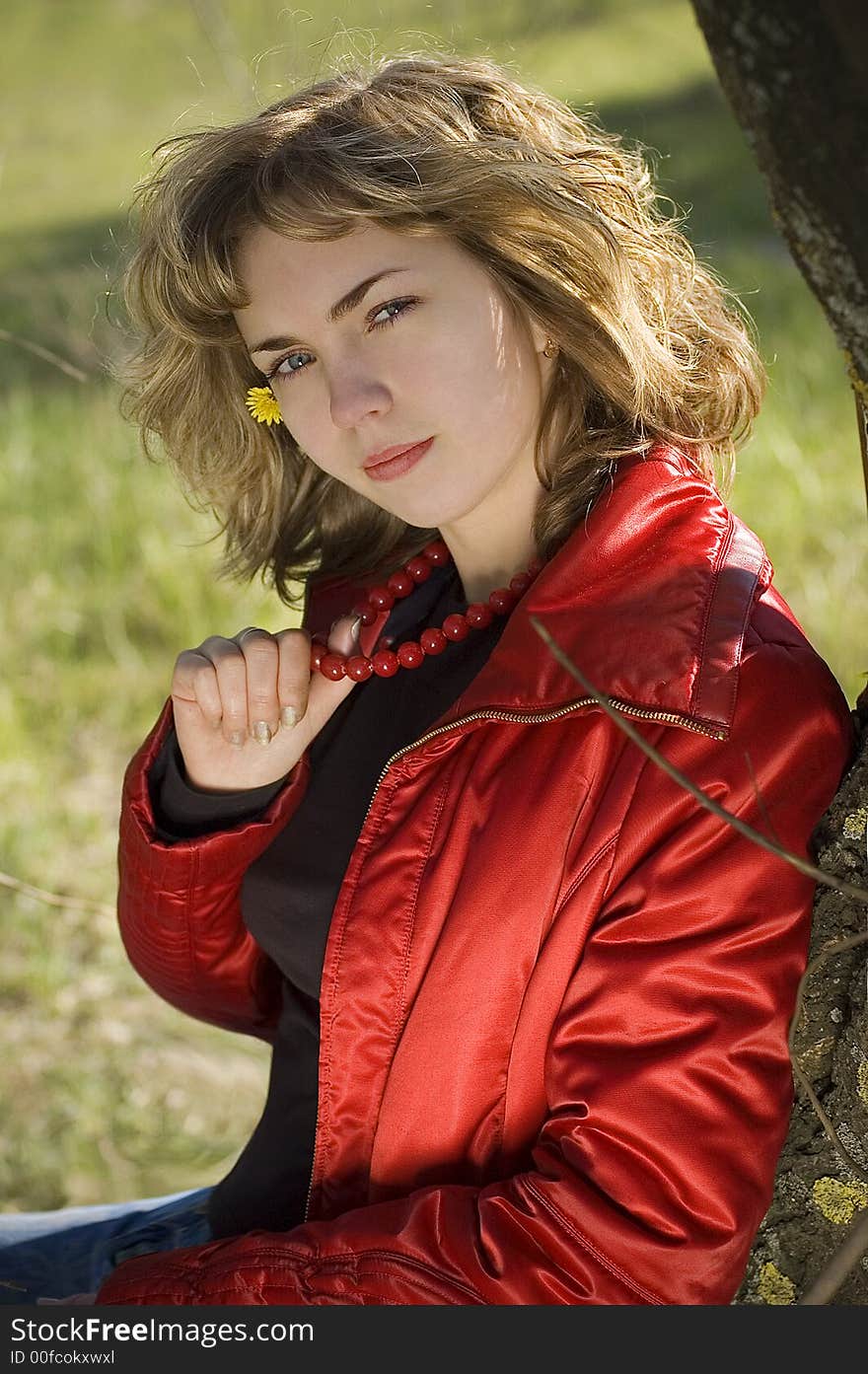 Young pretty blond with red beads and a dandelion outdoor. Young pretty blond with red beads and a dandelion outdoor