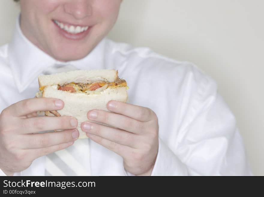 Businessman showing us his lunch which is a sandwhich he's going to eat. Businessman showing us his lunch which is a sandwhich he's going to eat