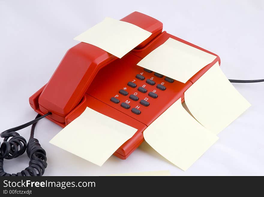 Red telephone with yellow memo paper. Red telephone with yellow memo paper