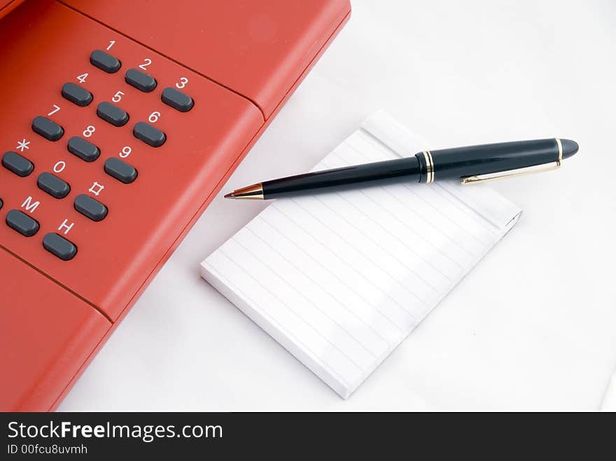 Red telephone with noteblock and pencil