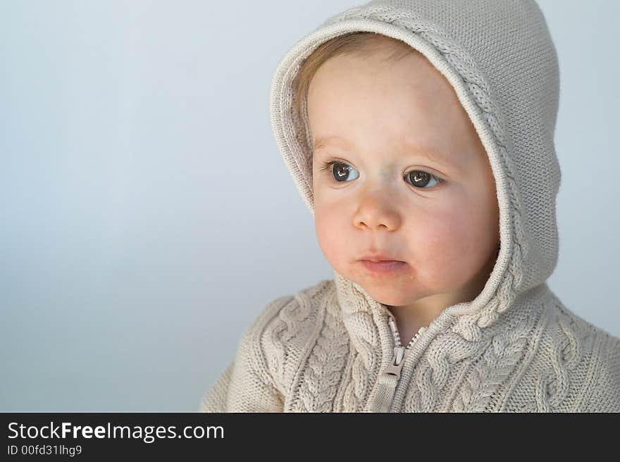 Image of cute baby wearing a hooded sweater. Image of cute baby wearing a hooded sweater