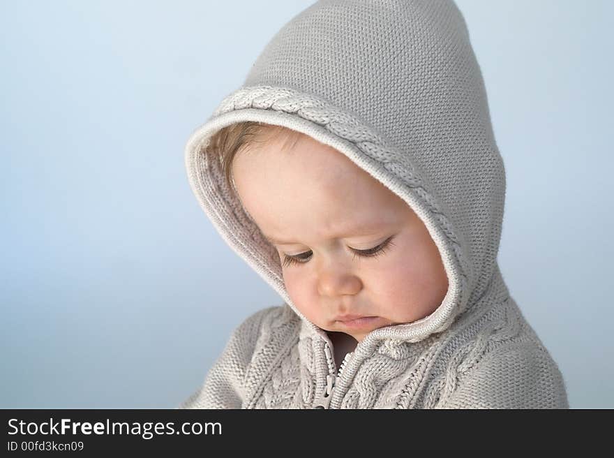 Image of cute baby wearing a hooded sweater. Image of cute baby wearing a hooded sweater