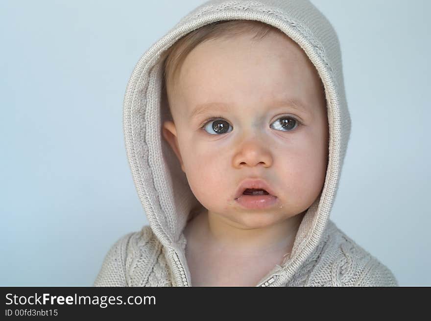 Image of cute baby wearing a hooded sweater. Image of cute baby wearing a hooded sweater