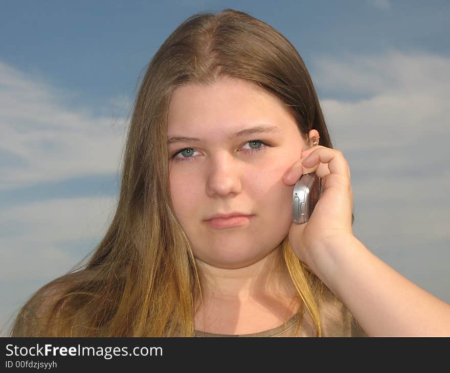 Young girl talks by the cell phone. Young girl talks by the cell phone