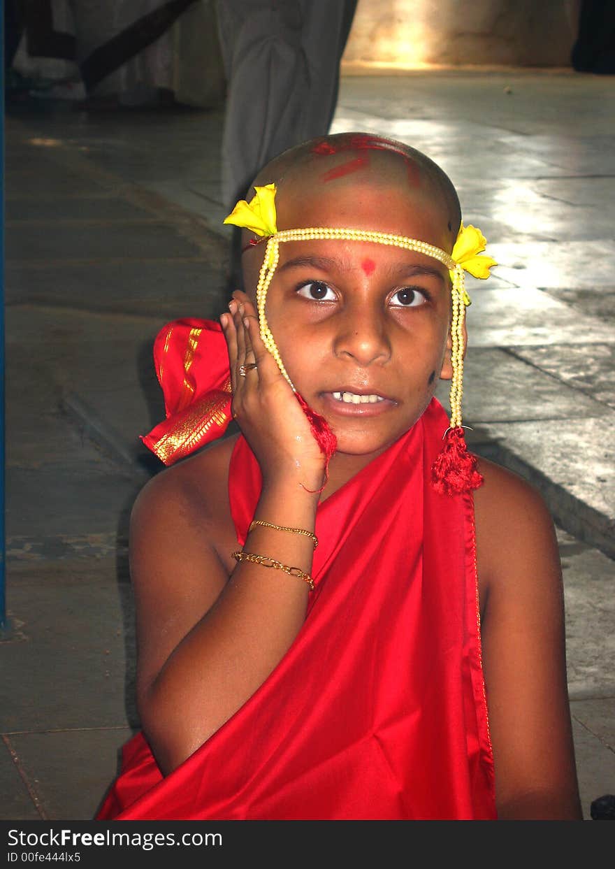 A boy chanting mantra in a Hindu religious ritual of thread ceremony.