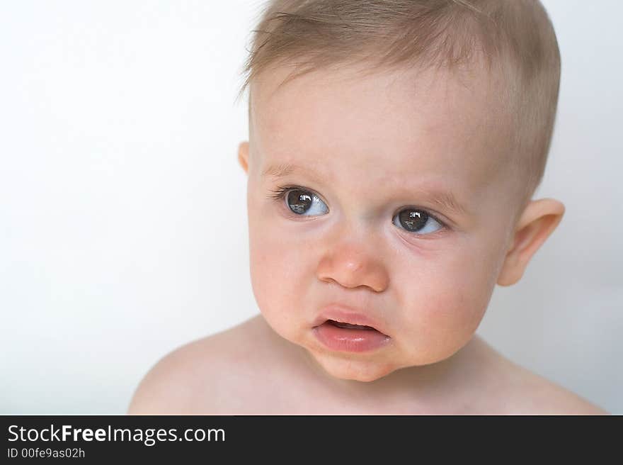 Image of beautiful 11 month old baby boy  sitting in front of a white background. Image of beautiful 11 month old baby boy  sitting in front of a white background