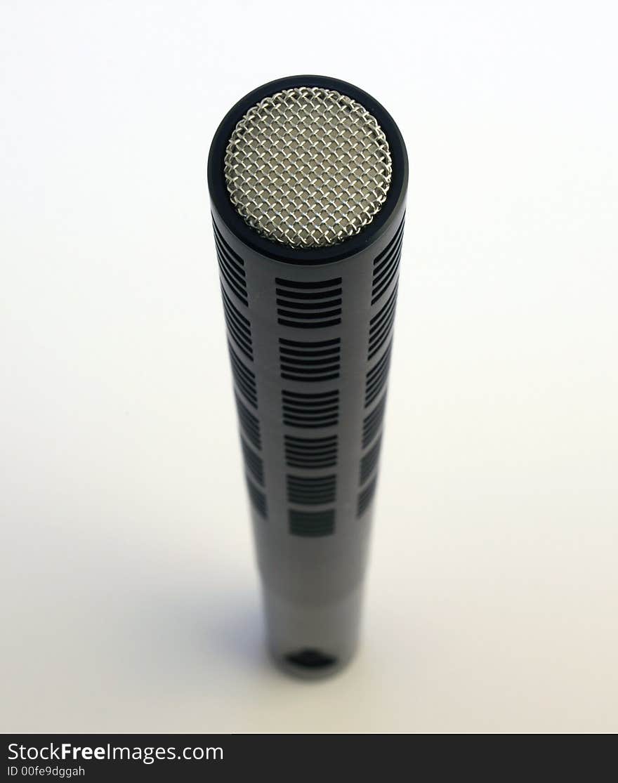 Close up of an upright Shotgun microphone against white background. Close up of an upright Shotgun microphone against white background