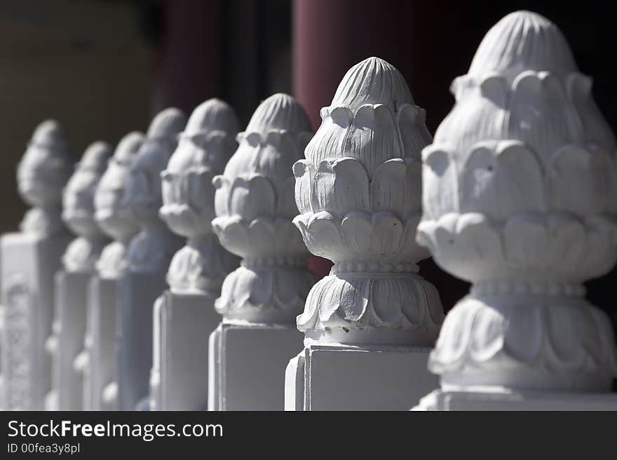 Ornaments on top of posts of a railing of a chinese temple. Selective focusing. Ornaments on top of posts of a railing of a chinese temple. Selective focusing.