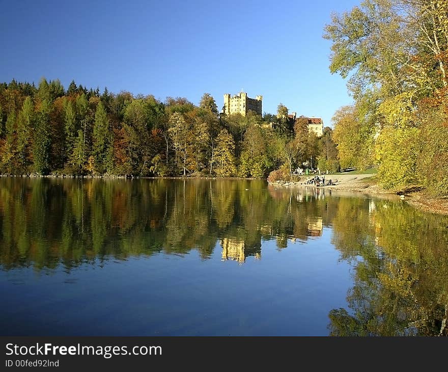 Royal castle Hohenschwangau, Bavaria, Germany. Alpensee in a foreground, blue sky in background.