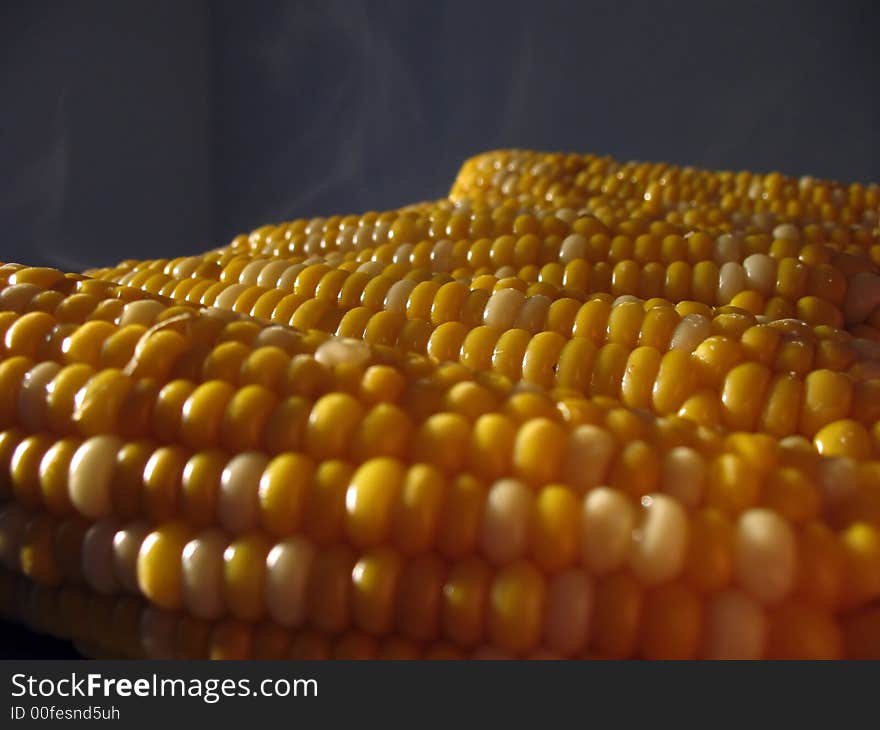 Hot freshly baked steaming corncobs