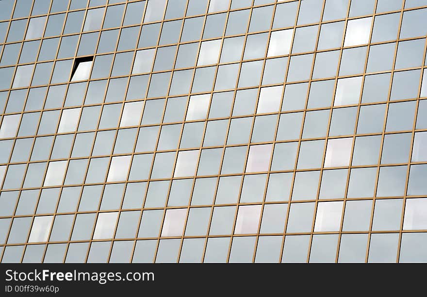 Modern business building with windows reflecting sun shine