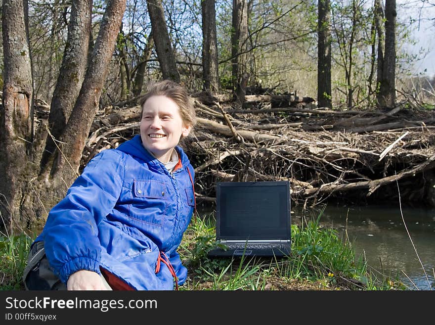 Woman with notebook at nature near small river