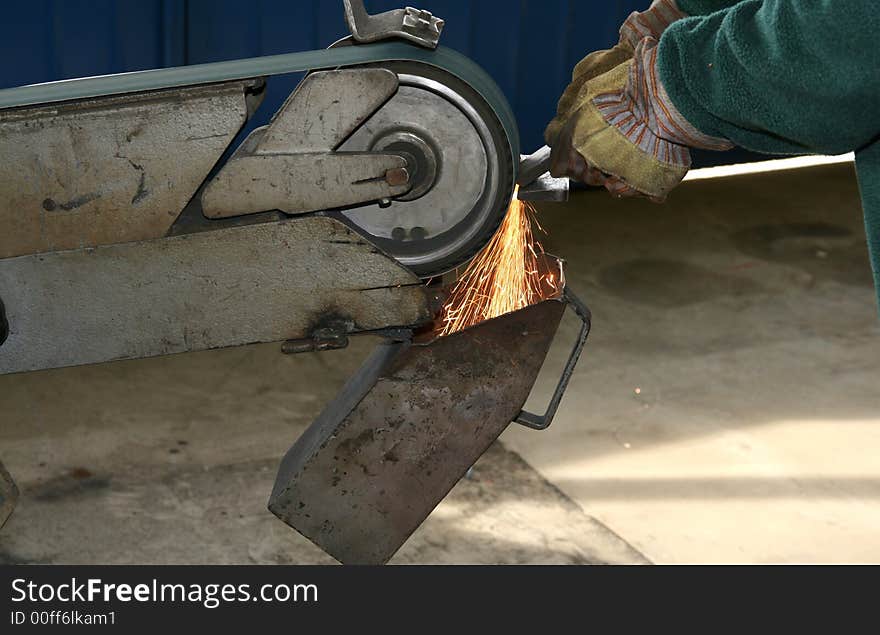 Steel being grinded in a mechanical workshop. Steel being grinded in a mechanical workshop