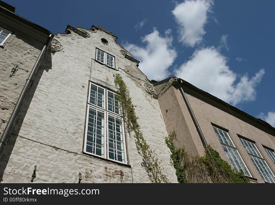 Old house facade agains the cloudy sky