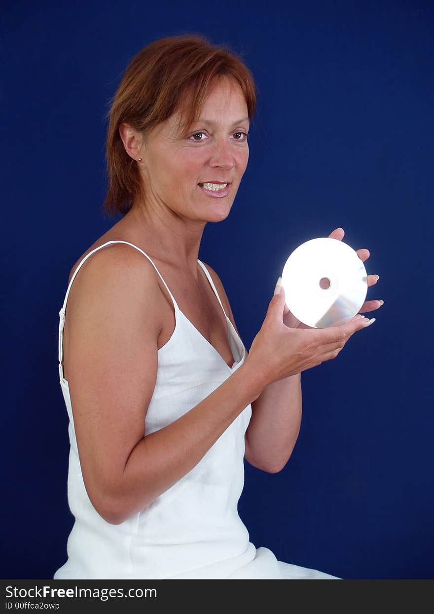 Lady with CD dressed in white middleaged