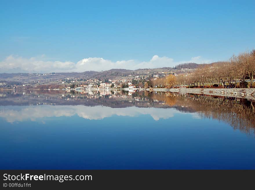 Lake landscape with reflected country and hills