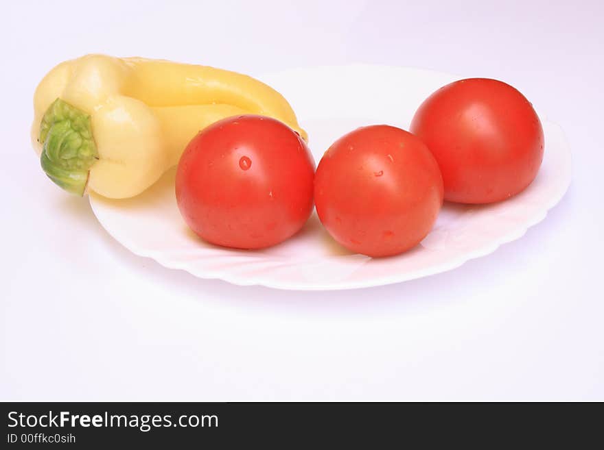 The fresh isolated vegetable on a white plate. The fresh isolated vegetable on a white plate