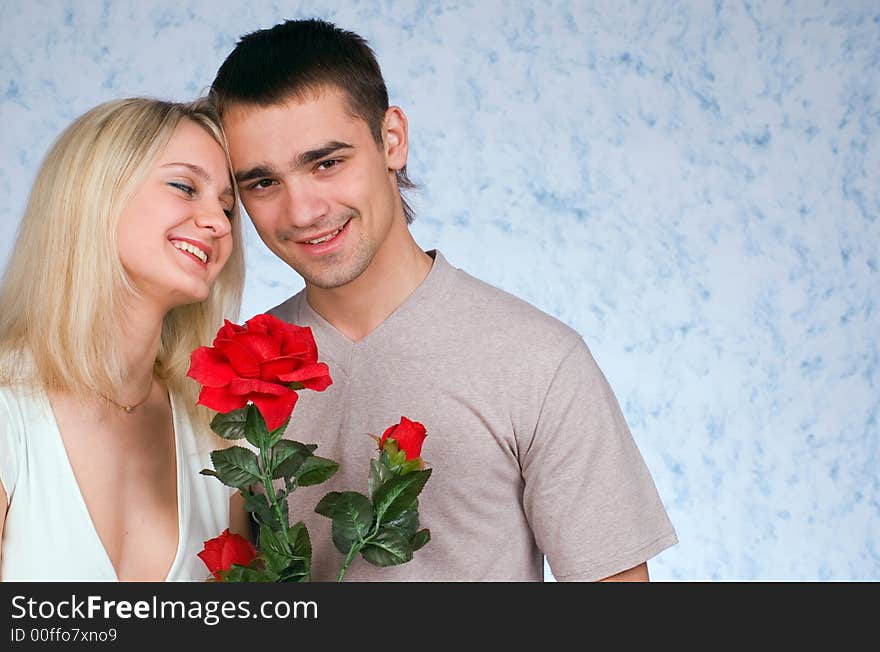 The guy, girl and a rose on blue background. The guy, girl and a rose on blue background