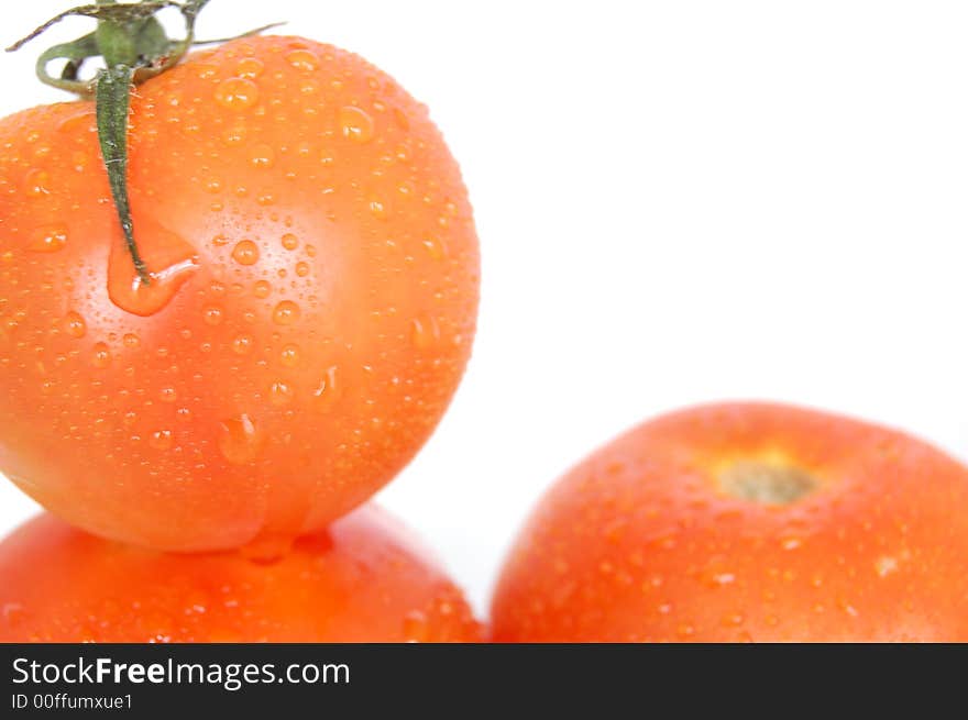 Some healthy red tomatoes on a white back drop setting. Some healthy red tomatoes on a white back drop setting.