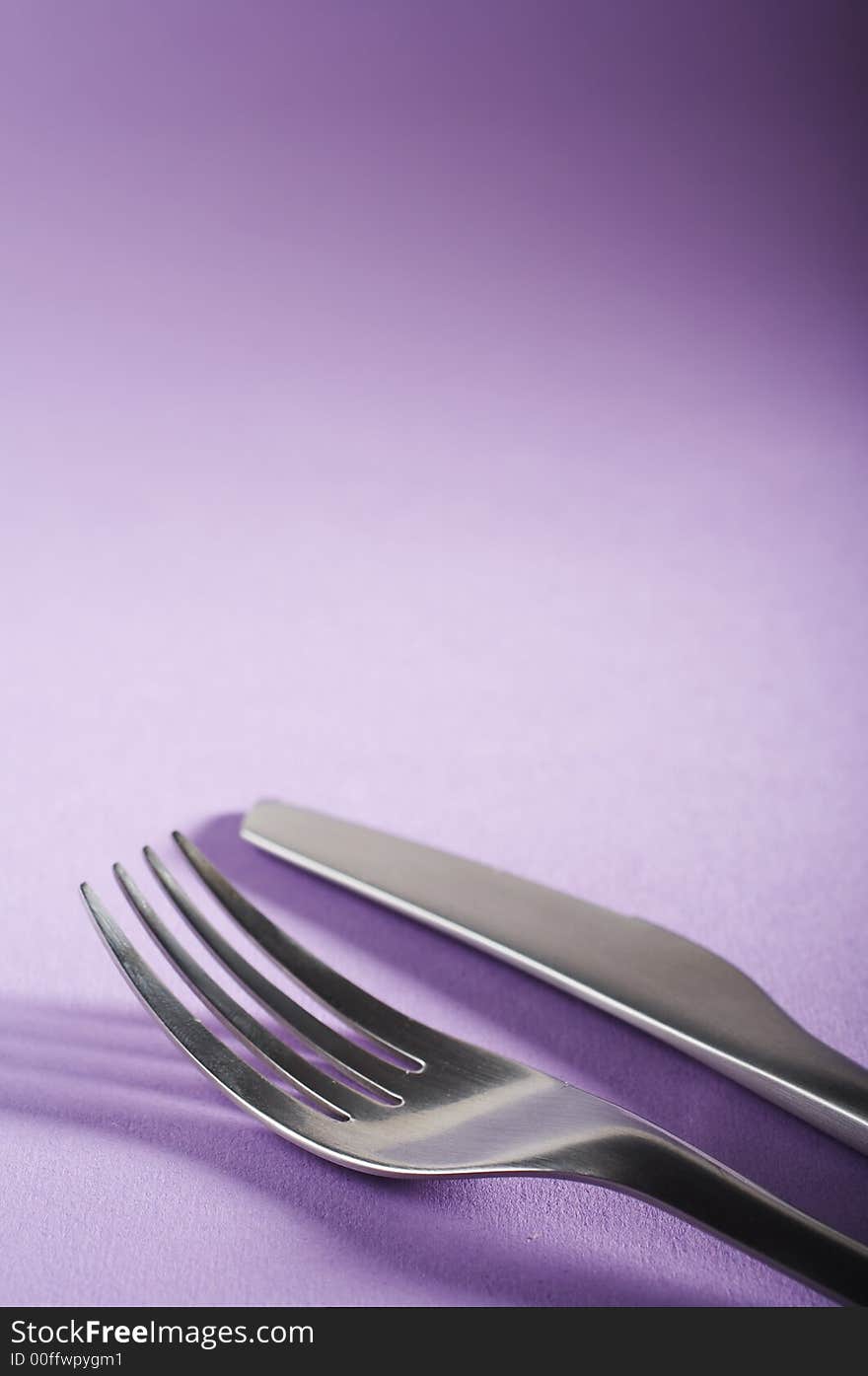 Fork and spoon on the purple table