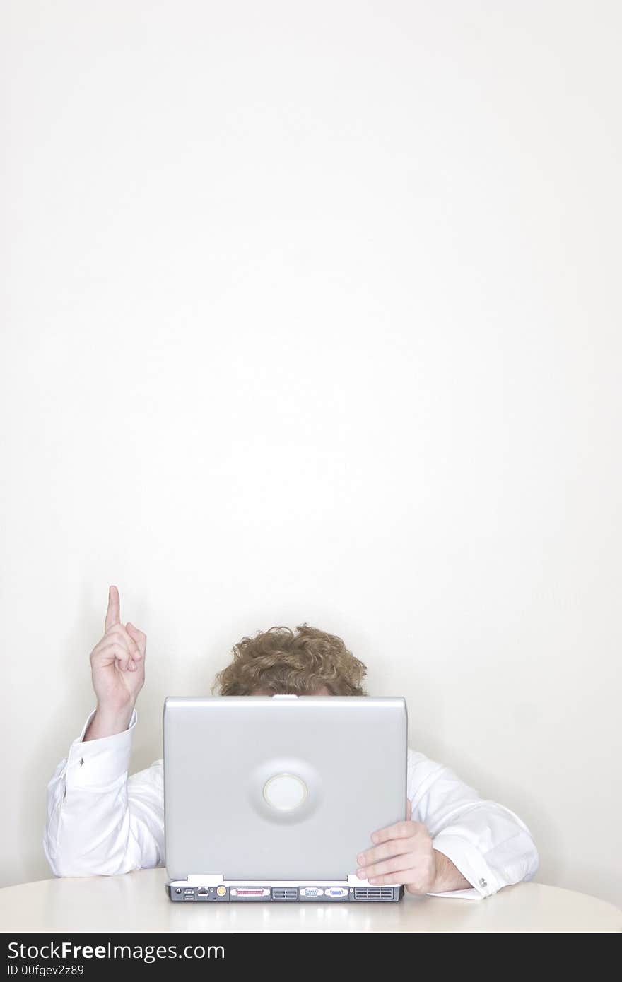 Businessman working on his laptop with his hand and finger raised for success. Businessman working on his laptop with his hand and finger raised for success