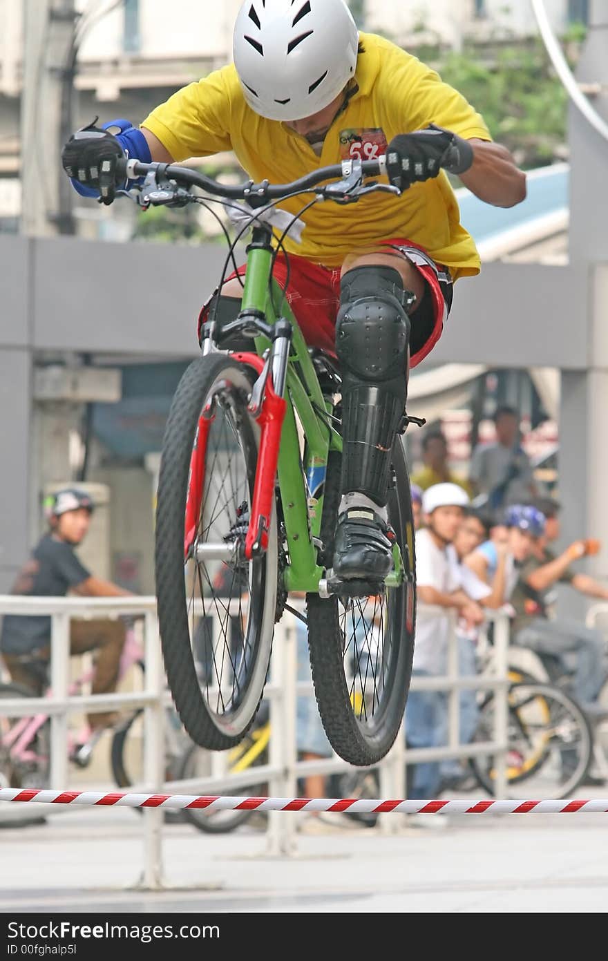 Mountain biker jumps an obstacle during a competition. Mountain biker jumps an obstacle during a competition