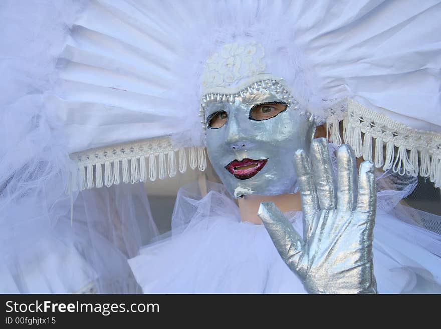 Models dresed in venetian masks are ready for carnival walk