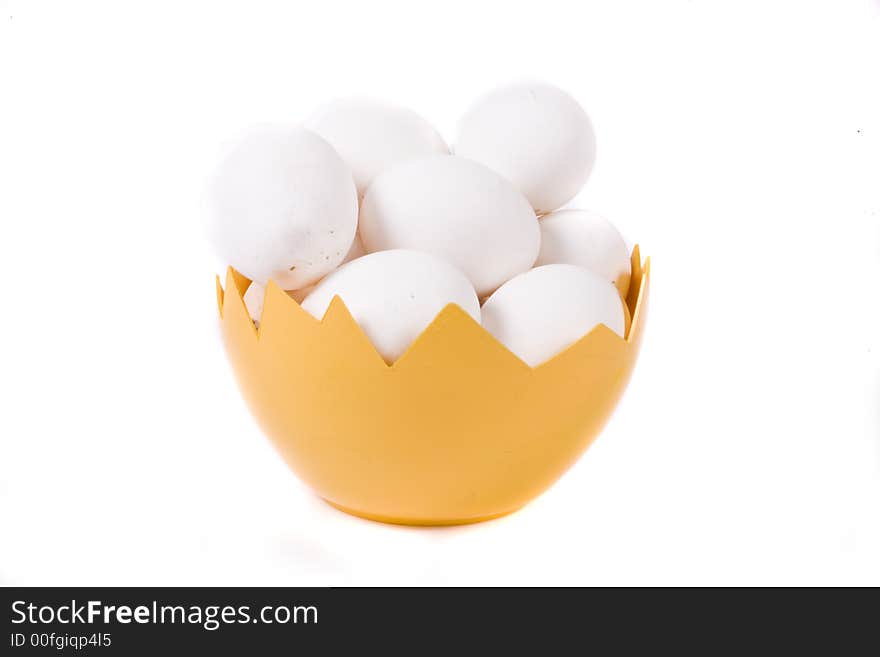 Many eggs in yellow eggshell on white background