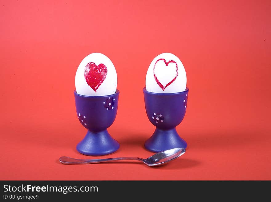 Two eggs in heart on red background