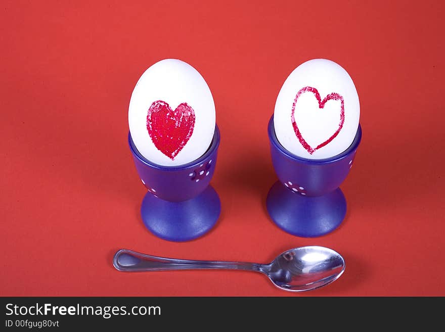 Two eggs in heart on red background