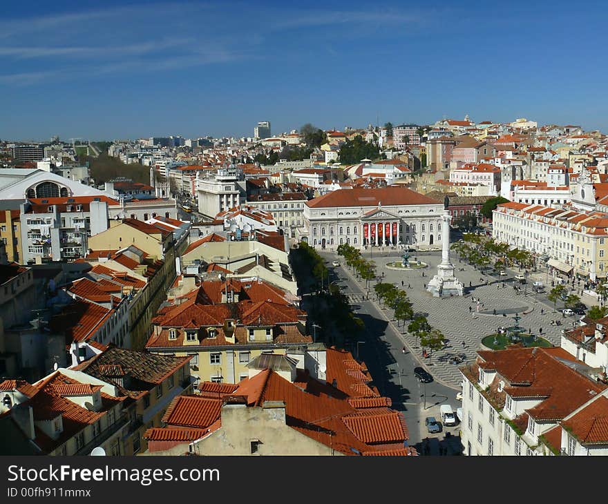 View of downtown Lisbon from Santa Justa's elevator showing the main central square of Rossio with statue of Pedro IV, the National Theater, the Mint House and many other landmark places of the town. View of downtown Lisbon from Santa Justa's elevator showing the main central square of Rossio with statue of Pedro IV, the National Theater, the Mint House and many other landmark places of the town