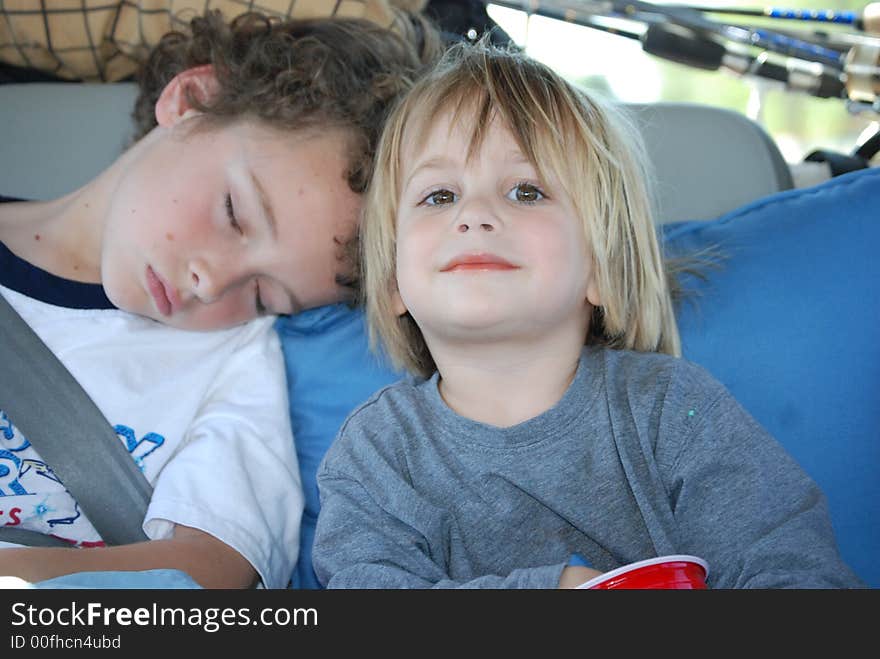 Brother supporting his older brother s he is sleeping on his shoulder. Brother supporting his older brother s he is sleeping on his shoulder