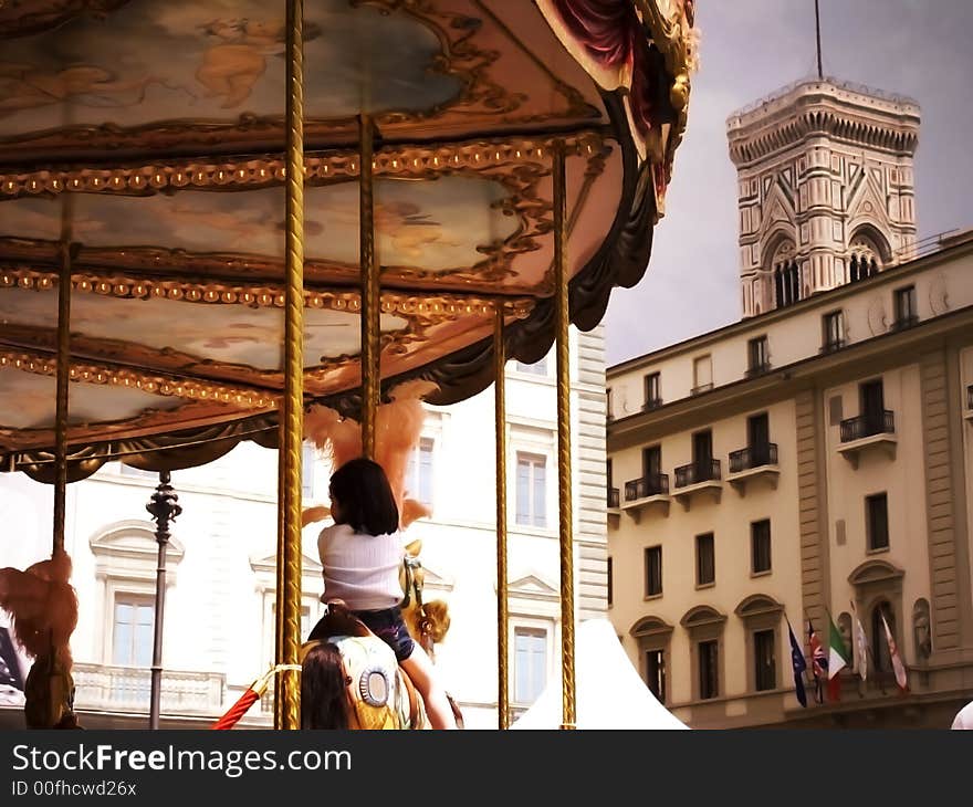 Young girl riding on a merry-go-round in Florence, Italy. Young girl riding on a merry-go-round in Florence, Italy