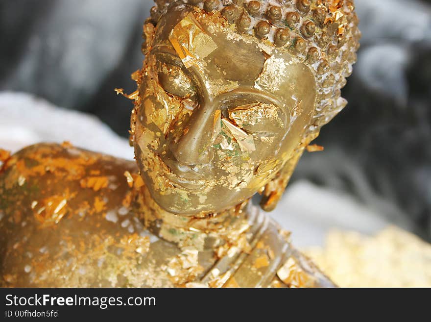 Close-up of a gold Buddhist statue in Thailand - travel and tourism