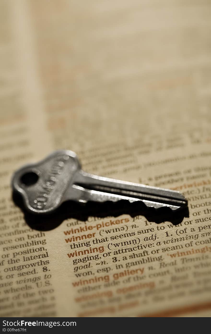 Key to winning - macro shot of key and dictionary