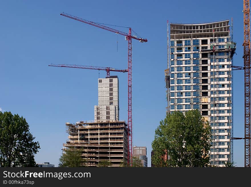 Two office buildings under construction

<a href=http://www.dreamstime.com/search.php?srh_field=building&s_ph=y&s_il=y&s_sm=all&s_cf=1&s_st=wpo&s_catid=&s_cliid=301111&s_colid=&memorize_search=0&s_exc=&s_sp=&s_sl1=y&s_sl2=y&s_sl3=y&s_sl4=y&s_sl5=y&s_rsf=0&s_rst=7&s_clc=y&s_clm=y&s_orp=y&s_ors=y&s_orl=y&s_orw=y&x=32&y=17> See more buildings</a>