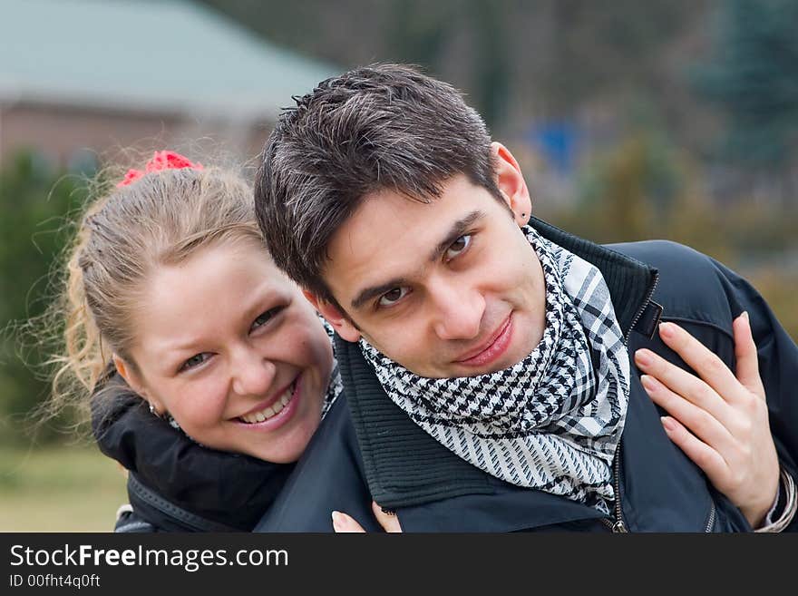 Young girl hugs a young man, diagonal image. Young girl hugs a young man, diagonal image