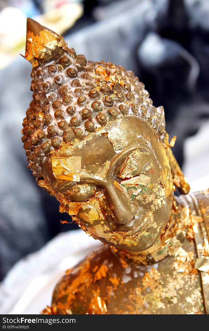 Close-up of a gold Buddhist statue in Thailand - travel and tourism