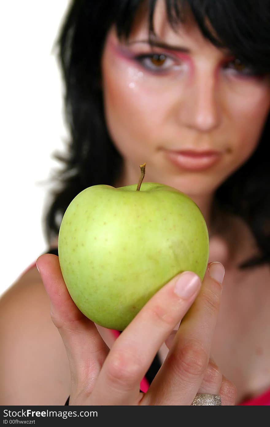 Young girl with green apple, isolated on white, focus in the apple. Young girl with green apple, isolated on white, focus in the apple