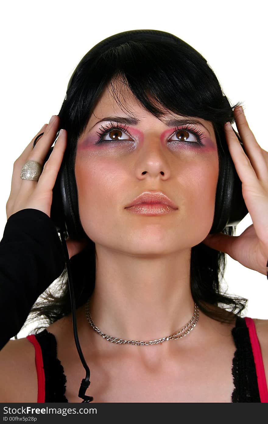 Beautiful brunette girl listening music, isolated on white background