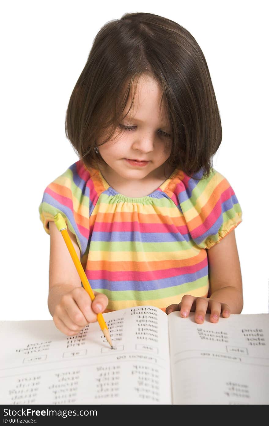 Elementary school girl studying from book, isolated over white