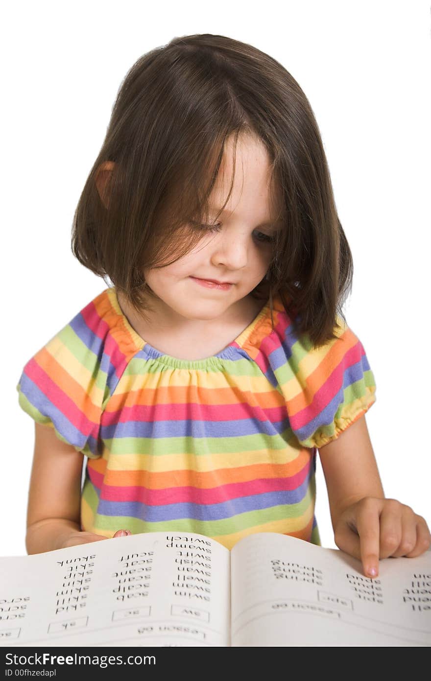 Elementary school girl studying from book, isolated over white