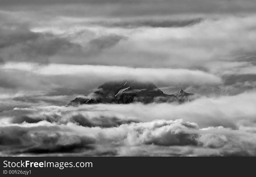 Strong black and white image of Mount Cook through clouds. Strong black and white image of Mount Cook through clouds