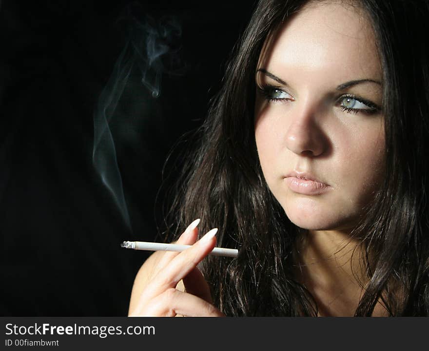 Young girl in black top with cigarette. Young girl in black top with cigarette