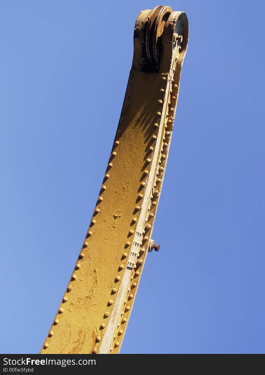 Detail of the crane in the harbor, clear blue sky background. Detail of the crane in the harbor, clear blue sky background