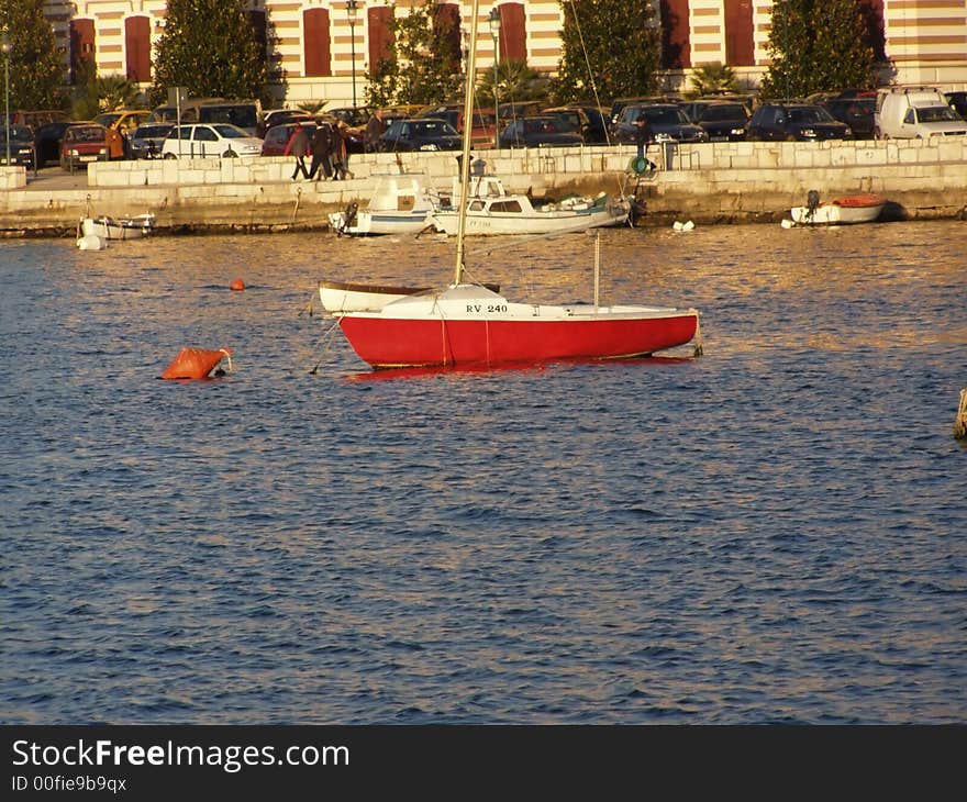 Red sailing boat in the port