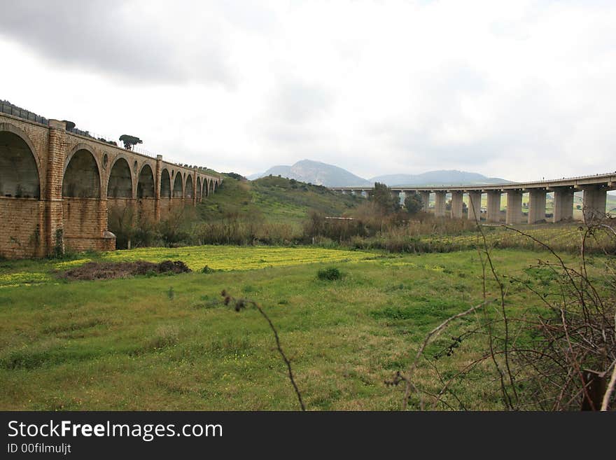 Country bridges for rails. Season Autumn. Green Cultivations. Fields and meadows Sicily. Italy