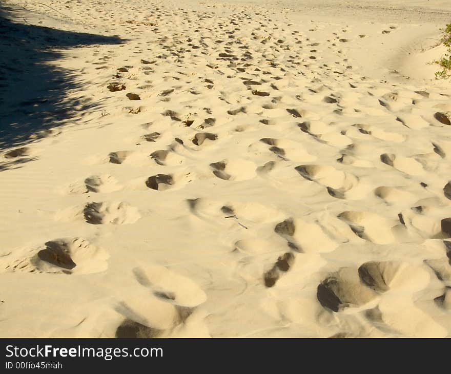 Footprints on the sand down hill