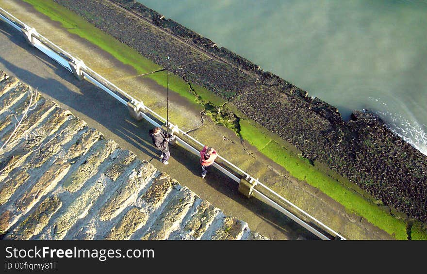 View of two fishermen on Calais harbour